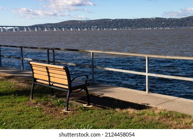 Empty Bench Along The Hudson River At Devries Park In Sleepy Hollow New York