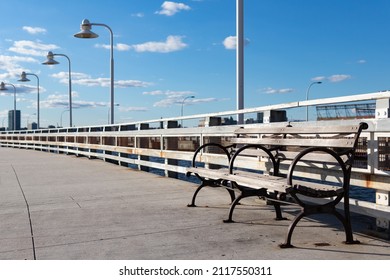 Empty Bench Along A Pier At Hudson River Park In New York City