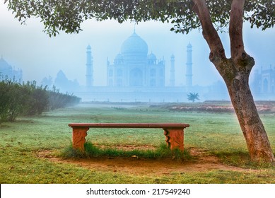 Empty bench by Taj Mahal hidden in morning fog