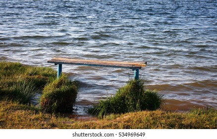 Empty bench overlooking a lake