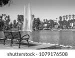 An empty bench overlooking the water feature on Echo park lake, Echo Park, CA, USA