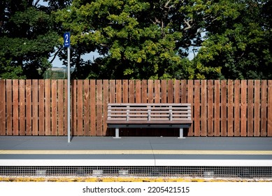 Empty bench and platform at a rural train station