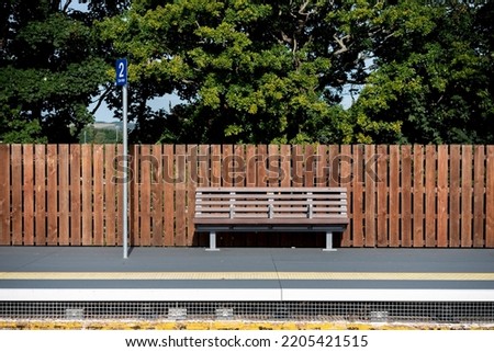 Empty bench and platform at a rural train station