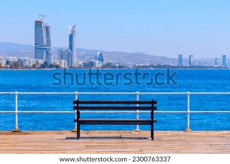 Empty bench at sea coast . Limassol city in Cyprus at Mediterranean Sea