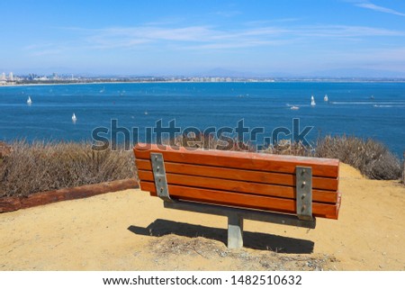 An empty bench sits overlooking San Diego bay on the Bayside Trail at Cabrillo National Monument in Point Loma, California.