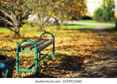 Empty Bench in Sunlit Autumn Park with Colorful Falling Leaves and Clear Pathway - Powered by Shutterstock