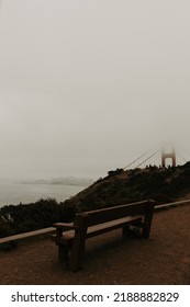 Empty Bench At Viewpoint Of San Francisco Bay Landscape And The Tourist Attraction Golden Gate Bridge. Morning With Fog And Overcast Weather. Photo Taken In San Francisco, California, USA