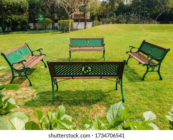 Empty Benches Facing Each Other In A Green Park