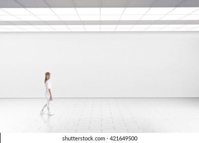 Empty Big Hall Wall Mockup. Woman Walk In Museum Gallery With Blank Wall. White Clear Stand Mock Up Lobby. Display Artwork Presentation. Art Design Empty Floor. Expo Studio  Loft Corridor.