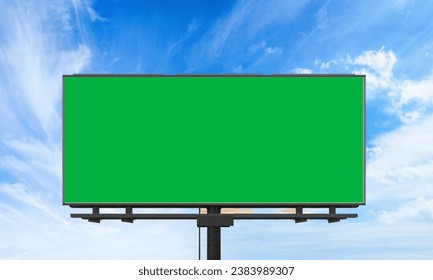 Empty billboard with chroma key green screen, on blue sky with clouds, advertisement concept, screen, green background, panoramic view  - Powered by Shutterstock