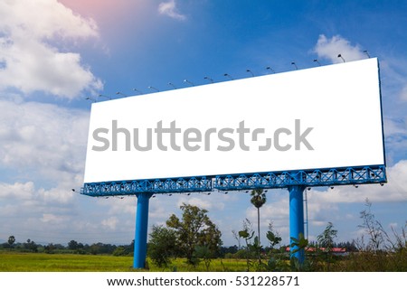 Empty billboard in front of beautiful cloudy sky