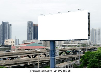 Empty billboard on a road in Thailand Blank billboard with copy space for text or content. Simulate an empty billboard in a big city. Overcast sky. Space for your advertisements. - Powered by Shutterstock