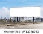 Empty billboard on the side of a highway. The billboard is located in a city, and it is facing the highway. The billboard is large and rectangular. Background of the billboard is white, clipping path.