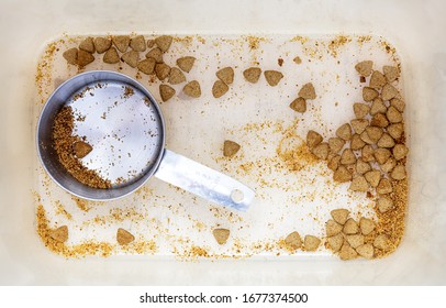 Empty Bin With Low Supply Of Dry Kibble Dog Food In Need Of Replenishment