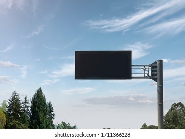 Empty Black Digital Road Sign With Clouds And Trees In Sunny Day 