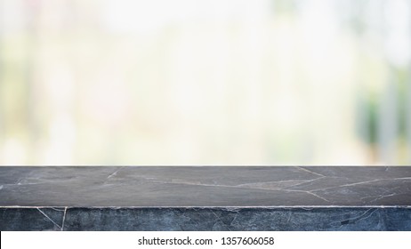 Empty black marble stone table top and blurred bokeh cafe and restaurent interior background - can used for display or montage your products.
