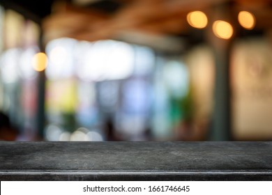 Empty black marble stone table top and blurred coffee shop and restaurant interior background - can used for display or montage your products.