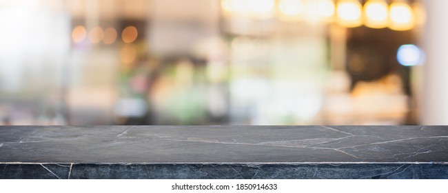 Empty black marble stone table top and blur glass window interior shopping mall banner mock up abstract background - can used for display or montage your products.