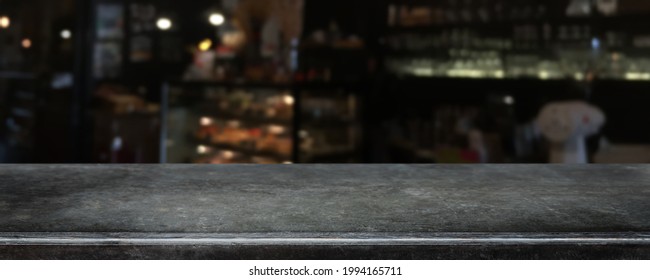 Empty black marble stone table top and blurred coffee shop, cafe and restaurant interior background - can used for display or montage your products.
