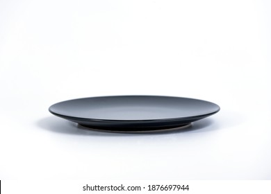 Empty Black Plate Isolated On White Background Side View, Selective Focus