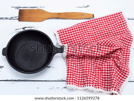 empty black round cast-iron frying pan