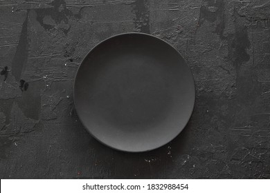 Empty Black Slate Plate On Dark Stone Table. Food Background For Menu, Recipe. Table Setting. Flatlay, Top View. Mockup For Restaurant Dish