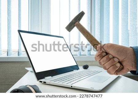 empty blank laptop screen for design or text message. copy space. Businessman breaks a laptop with an empty white screen with a hammer