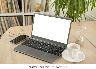 empty blank mockup, cup coffee, white laptop screen display for advertising, having virtual meeting, remote work, search online, home office, room interior with plant - Powered by Shutterstock