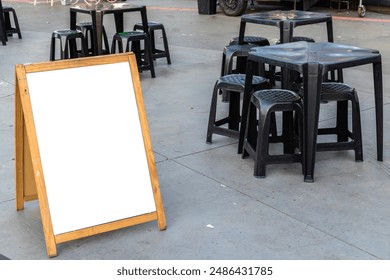 Empty blank for mockup sandwich chalkboard next to tables and chairs and a food truck in a square in Brazil - Powered by Shutterstock