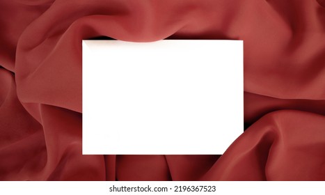 Empty Blank Postcard Template On Red Fabric. Cope Space. Flat Lay, Top View, Copy Space. 