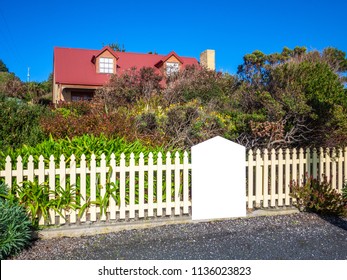 Empty Blank Poster At Front Of Country House And Front Yard Garden. Background Texture Of Advertisement Sign Mock Up Template. Concept Of House For Sale, Real Estate To Let Or Property For Lease.