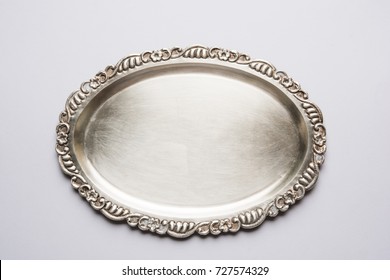 Empty Or Blank Silverware Or Oval Shape Silver Plate With Decorative Border, Isolated Over White Background, Selective Focus