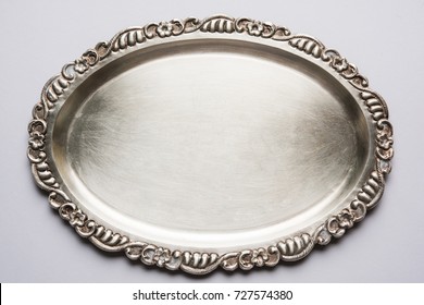 Empty Or Blank Silverware Or Oval Shape Silver Plate With Decorative Border, Isolated Over White Background, Selective Focus