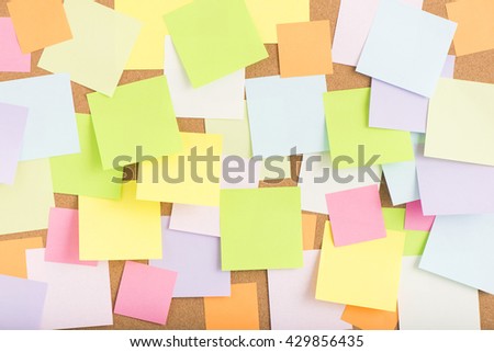 Empty blank sticky notes on notice board in office. Background or backdrop for business information. Concept image of communication or reminder with copy space. 