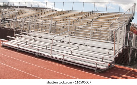 Empty Bleachers Of  High School Football And Track And Field Stadium