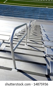 Empty Bleachers At A Highschool Football Field