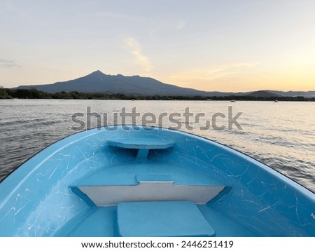 Empty blue boat bow on nature background in sunset time