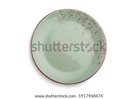 Empty blue dotted ceramic plate isolated on white background. Top view, close up.