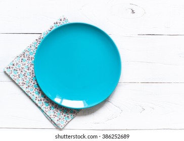 Empty Blue Plate And Napkin At Wooden Table. View From Above, Copy Space.