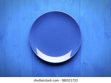 Empty Blue Plate On Blue Wooden Table