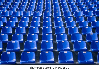 Empty blue seats with numbers in the stadium. - Powered by Shutterstock