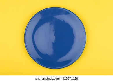 Empty Blue Shiny Plate On Yellow Background