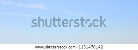 Empty Blue Sky Background and Simple Natural Texture Template of Pale Blue Sky with Small Clouds. Backdrop of Light Blue Color, Blur Sky Texture, Blank Sky Wallpaper Poster for Copy Space.