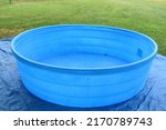 Empty blue swimming pool in a yard