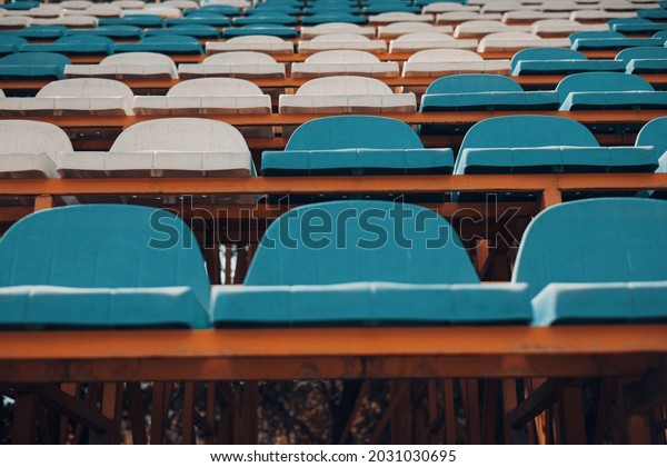 Empty blue\
white stadium seats, empty\
bleachers