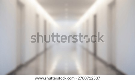 An empty, blurred modern white corridor stretches into the distance with doors on either side and illuminated ceiling lights.