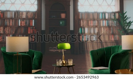 Empty book filled traditional study room with green armchairs and warm wood tones exudes a cozy upscale atmosphere. Space ideal for elite aristocracy gatherings and drinking whiskey.