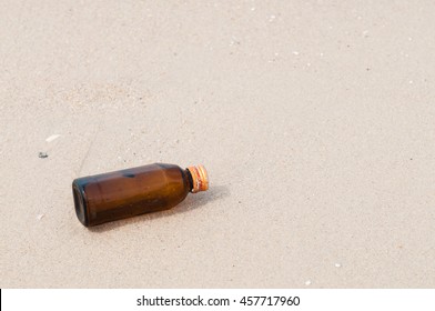 Empty bottle on the beach.