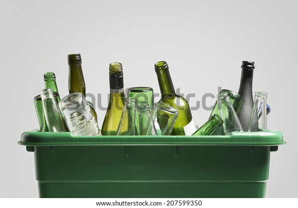 Empty bottles in green container