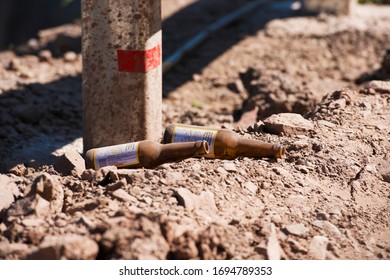 Empty bottles lying side of the road by travellers which cause pollution. 